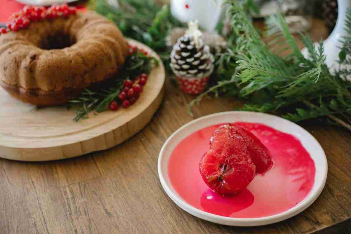delicious poached pears with syrup near cake on table